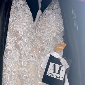 Wedding dress never worn or been out of bag. Includes matching hip length veil